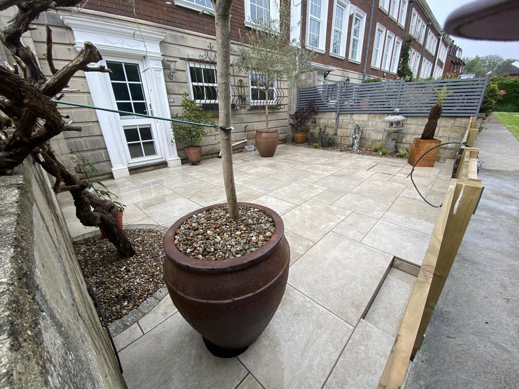 Porcelain patio at a large property with planters